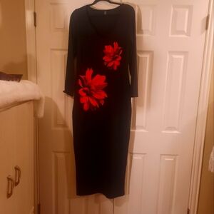Long fitted maxi black dress with red flowers on front of dress.